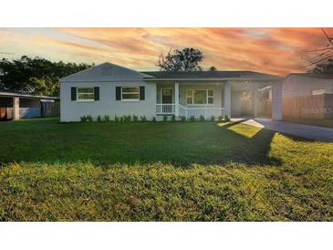 Charming bungalow with a newly renovated exterior, featuring a landscaped lawn and driveway at 527 Sunrise Dr, Orlando, FL 32803