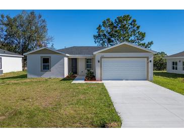 Newly built home with a two-car garage and front yard at 1603 Tench Ct, Kissimmee, FL 34759