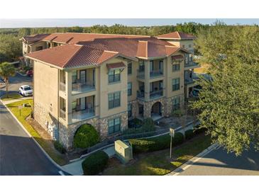 Spanish-style condo building with tile roofs and balconies at 902 Charo Pkwy # 636, Davenport, FL 33897