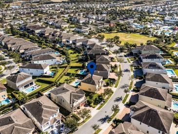 Aerial view showing home's location in a community with pools and lush landscaping at 7639 Wilmington Loop, Kissimmee, FL 34747