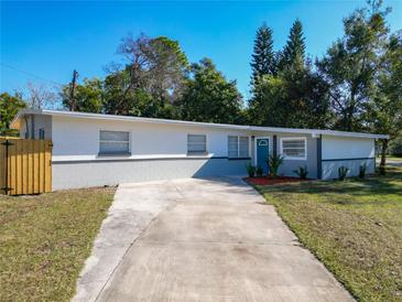 Newly renovated single story home with gray exterior, wood fence, and long driveway at 101 Gerry Dr, Altamonte Springs, FL 32714