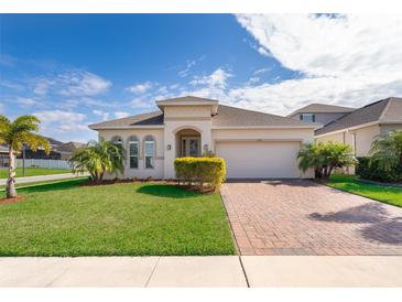 One-story house with a brick paved driveway and landscaping at 1721 Sunfish St, St Cloud, FL 34771