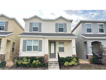 Two-story house with gray shutters and landscaping at 254 Bella Prestwick Blvd, Davenport, FL 33837