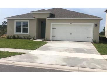 One-story house with attached garage and well-maintained lawn at 2672 Harmonia Hammock Rd, Harmony, FL 34773