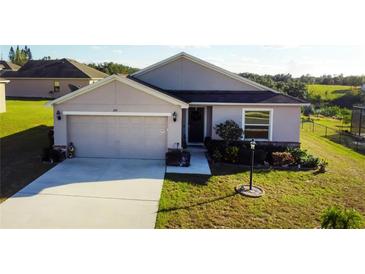 One-story house with a two-car garage and well-manicured lawn at 326 Dinner Lake Ct, Lake Wales, FL 33859