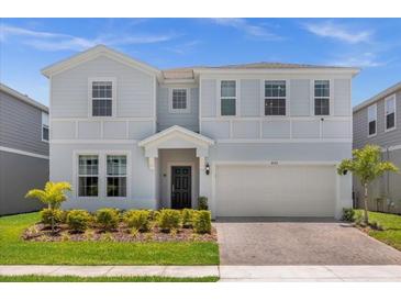 Charming two-story home with a welcoming front entrance and landscaped yard at 4141 Lana Ave, Davenport, FL 33897