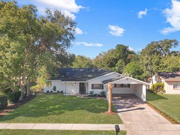 Newly renovated home with a carport and well-manicured lawn at 1234 Lynwood Ave, Apopka, FL 32703