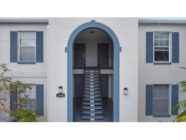 View of the building's exterior with stairs leading to the upper units at 1006 Plantation Dr # F12, Kissimmee, FL 34741