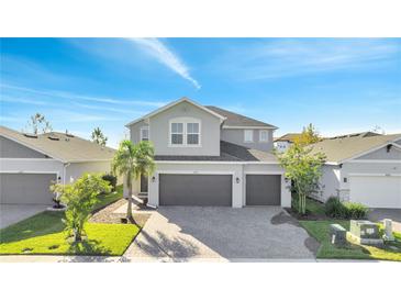 Two-story house with gray siding, gray roof, and a two-car garage at 629 Big Pine Ave, Minneola, FL 34715