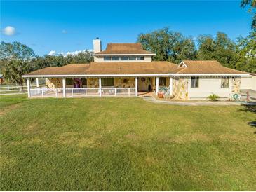 Ranch-style home with a large yard and wrap-around porch at 2801 S Granada Blvd, Kissimmee, FL 34746