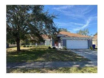 Single-story house with attached garage and well-maintained lawn at 308 Coventry Estates Blvd, Deltona, FL 32725
