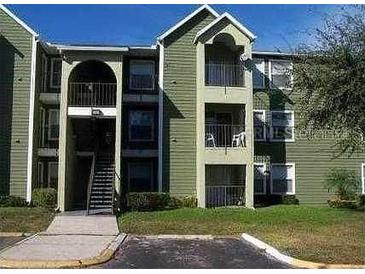 Green two-story building with balconies and stairs at 4728 Walden Cir # 37, Orlando, FL 32811