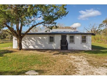 Newly constructed home with metal roof, fresh landscaping, and a spacious yard at 4950 Nova Ave, St Cloud, FL 34773