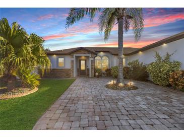 Inviting home exterior with a paved walkway and landscaping at 8 Catalina Ct, Kissimmee, FL 34758