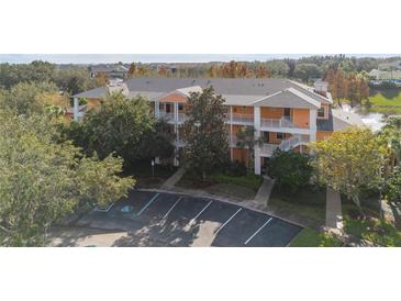 Two-story condo building with parking and landscaped grounds at 911 New Providence # 911, Davenport, FL 33897