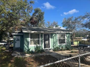 Quaint teal house with a small front yard and fenced area at 3407 Avenue J Nw, Winter Haven, FL 33881