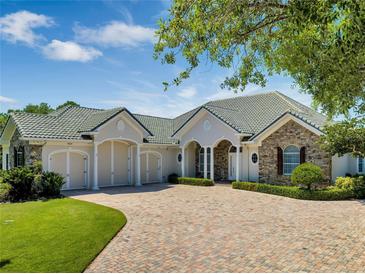 Beautiful stone and shingle home with 3-car garage at 1501 Sunset Pointe Pl, Kissimmee, FL 34744