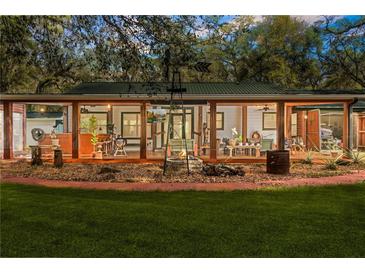 Expansive covered patio with fire pit, perfect for outdoor entertaining at 10820 Sw 31St Way, Webster, FL 33597