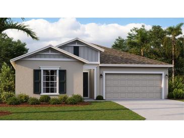 New home exterior features a two-car garage and attractive landscaping at 1153 Deepwater Cir, Eagle Lake, FL 33839