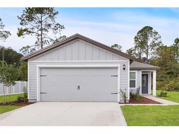 Two-car garage with gray siding at 616 Marion Oaks Blvd, Ocala, FL 34473