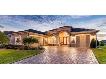 Beautiful two-story home with a paver driveway at 8339 Bridgeport Bay Cir, Mount Dora, FL 32757