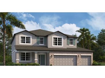 Two-story house with a two-car garage, gray siding, and a stone facade at 5263 Peony Ct, Lakeland, FL 33811