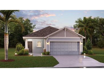 One-story home with light blue exterior, two-car garage, and landscaping at 2123 Green Valley St, Daytona Beach, FL 32124