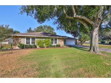 House exterior with a large tree in the front yard at 220 Coleman E Dr, Winter Haven, FL 33884