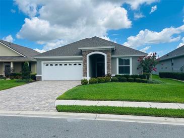 One-story home with a two-car garage and landscaped lawn at 7771 Lake James Blvd, Lakeland, FL 33810
