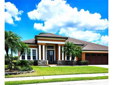 Two story house with columns and a three car garage at 5446 Pebble Beach Dr, Lakeland, FL 33812