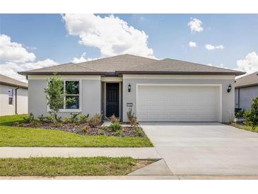 Single-story home with two-car garage and landscaped front yard at 8322 Sw 52Nd Lane Rd, Ocala, FL 34481
