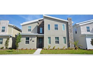 Modern two-story house with stone accents; new construction at 2857 Bookmark Dr, Kissimmee, FL 34746