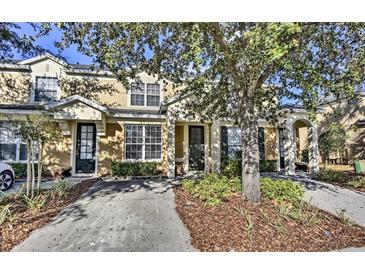 Two-story townhome with a welcoming front yard and driveway at 7663 Sir Kaufmann Ct, Kissimmee, FL 34747
