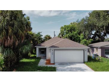 Newly built home with a two-car garage and landscaped yard at 604 W 12Th St, Lakeland, FL 33805