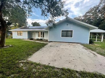 Ranch style home with blue siding, and a carport at 13659 Sw 115Th Pl, Dunnellon, FL 34432