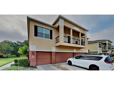 Tan two-story house with two car garage and balcony at 2217 Betsy Ross Ln # A, St Cloud, FL 34769