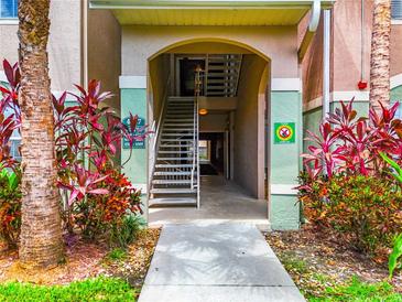 Community building entrance with stairs and landscaping at 4897 Cypress Woods Dr # 6107, Orlando, FL 32811