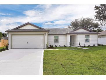 New construction home with attached garage and yard at 16984 Sw 40Th Cir, Ocala, FL 34473