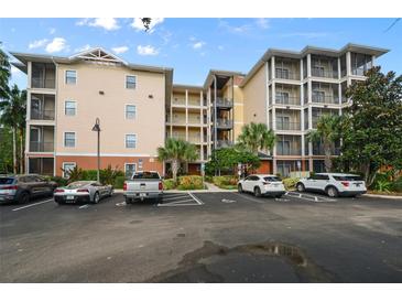 Condo building exterior with ample parking and surrounding landscaping at 3050 Pirates Retreat Ct # 502, Kissimmee, FL 34747