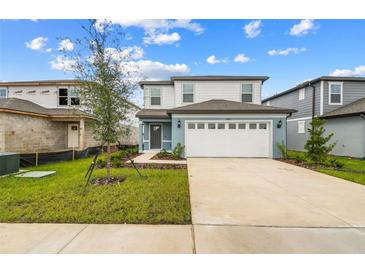 Two-story house with attached garage and landscaping at 285 Woodsage Pl, Lake Alfred, FL 33850