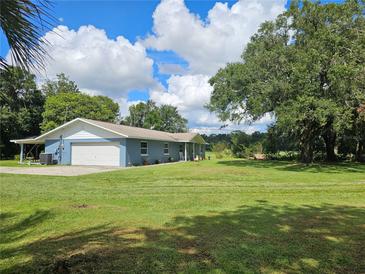 Charming blue home with a large front yard and mature trees at 4810 N Galloway Rd, Lakeland, FL 33810