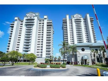 Twin highrise building exterior with fountain and landscaping at 13415 Blue Heron Beach Dr # 1101, Orlando, FL 32821