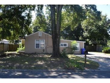 A charming single-story house with a front yard and mature trees at 1214 W Marjorie St, Lakeland, FL 33815