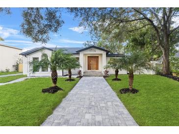 Renovated home with walkway, landscaping, and palm trees at 1716 Palmer Ave, Winter Park, FL 32789