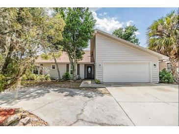 House exterior with driveway and landscaping at 2305 Flaming Arrow Dr, Lakeland, FL 33813