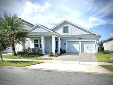 Two-story house with a two car garage and landscaped lawn at 4552 Sequel Rd, Kissimmee, FL 34746