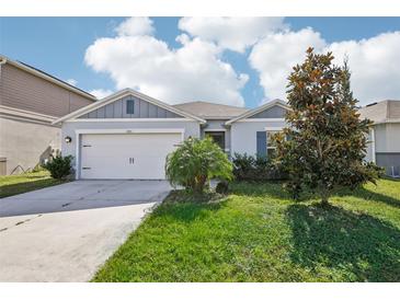 Single-Gathering home with two car garage and front yard at 1383 Pompay Dr, Davenport, FL 33896