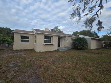 Charming single story home with a well-maintained lawn at 1124 Sunshine Ave, Leesburg, FL 34748