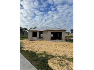 New construction home with block exterior and attached garage at 242 Green St, Auburndale, FL 33823