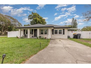 Newly renovated home with a landscaped yard and driveway at 132 James St, Auburndale, FL 33823
